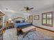 Comfortable main bedroom with a king bed, wood flooring, and shuttered windows at 16326 Kalli Way, Dade City, FL 33523