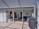 Covered patio with comfortable seating, grill and open access to the home's interior at 16326 Kalli Way, Dade City, FL 33523