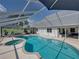 Backyard pool and spa with screened-in enclosure connected to the house at 16326 Kalli Way, Dade City, FL 33523