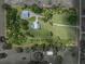 Aerial view outlining the spacious acreage, main house with pool, and separate workshop building at 16326 Kalli Way, Dade City, FL 33523
