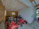 Shed interior with lawn equipment, white paneled ceiling, and an exterior door at 16326 Kalli Way, Dade City, FL 33523