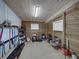 Organized shed interior with wooden walls, shelving, overhead lighting, and yard tools at 16326 Kalli Way, Dade City, FL 33523