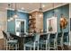 Chic bar area with pendant lighting, ample seating, and stylish decor for entertaining guests at 17244 Tortoise Crown Blvd, Land O Lakes, FL 34638