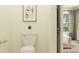 Bright bathroom featuring a toilet, minimalist decor, and view to the bedroom at 17244 Tortoise Crown Blvd, Land O Lakes, FL 34638