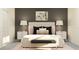 Comfortable bedroom showcasing a cushioned headboard, matching nightstands, and contemporary lamps at 17244 Tortoise Crown Blvd, Land O Lakes, FL 34638