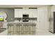 Bright and modern kitchen featuring white cabinets, stainless steel appliances, and a center island at 17244 Tortoise Crown Blvd, Land O Lakes, FL 34638