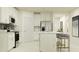 Modern kitchen featuring white cabinets, stainless steel appliances, and a center island with seating at 17244 Tortoise Crown Blvd, Land O Lakes, FL 34638