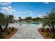 Resort-style pool surrounded by palm trees and lounge chairs, perfect for relaxation and leisure at 17244 Tortoise Crown Blvd, Land O Lakes, FL 34638