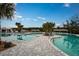 Expansive pool area with multiple swimming zones, lounge chairs, and tropical landscaping for a luxurious experience at 17244 Tortoise Crown Blvd, Land O Lakes, FL 34638