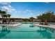 Large community pool with ample lounge chairs, perfect for relaxing and enjoying the sunny weather at 17244 Tortoise Crown Blvd, Land O Lakes, FL 34638
