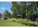 Well-maintained backyard with lush green grass and mature trees at 17321 Oak Ledge Dr, Lutz, FL 33549