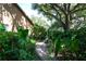Charming backyard pathway with lush greenery, plants, and trees at 17321 Oak Ledge Dr, Lutz, FL 33549