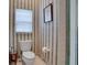 Cozy half bathroom featuring wallpaper, toilet, and vanity area at 17321 Oak Ledge Dr, Lutz, FL 33549
