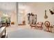 Open-concept living room features soaring ceilings, neutral walls, carpet flooring, and a formal dining area at 17321 Oak Ledge Dr, Lutz, FL 33549