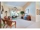 Spacious living room featuring neutral walls, carpet flooring, patio doors, and a piano at 17321 Oak Ledge Dr, Lutz, FL 33549