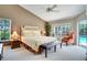 Bright main bedroom with ceiling fan, carpet flooring, and neutral walls at 17321 Oak Ledge Dr, Lutz, FL 33549