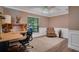 Office space with desk, chair, ceiling fan, crown molding, and a window view at 17321 Oak Ledge Dr, Lutz, FL 33549