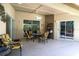 Cozy covered patio featuring comfortable seating, ideal for relaxing and enjoying the outdoor space at 17321 Oak Ledge Dr, Lutz, FL 33549