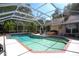 Sparkling pool surrounded by a screened enclosure, providing a private and enjoyable outdoor oasis at 17321 Oak Ledge Dr, Lutz, FL 33549