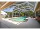 Inviting screened-in pool offering a refreshing escape with comfortable seating and a serene backyard view at 17321 Oak Ledge Dr, Lutz, FL 33549