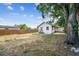 Large backyard with mature trees, a wooden fence, and plenty of open space at 1750 Dayton S St, St Petersburg, FL 33712
