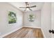 Bright bedroom with wood floors, two windows, and a ceiling fan at 1750 Dayton S St, St Petersburg, FL 33712