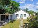 Attractive home with a quaint front yard, turquoise door, and convenient carport at 1750 Dayton S St, St Petersburg, FL 33712