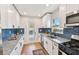Well-lit kitchen with updated cabinetry and stylish backsplash at 1750 Dayton S St, St Petersburg, FL 33712