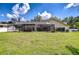 Beautiful home with a large screened lanai overlooking the lush green backyard at 17917 Clear Lake Dr, Lutz, FL 33548