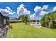 Expansive backyard with lush green grass and lake views, perfect for outdoor activities at 17917 Clear Lake Dr, Lutz, FL 33548
