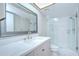 Modern bathroom featuring a white marble vanity, shower with glass door, and updated fixtures at 17917 Clear Lake Dr, Lutz, FL 33548