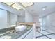 Contemporary bathroom vanity with a large mirror, granite countertop, white cabinetry, and black and white floor tiles at 17917 Clear Lake Dr, Lutz, FL 33548