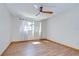 This bedroom features wood-look flooring and natural light from the window at 17917 Clear Lake Dr, Lutz, FL 33548