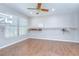Spacious walk-in closet with light wood floors, a ceiling fan, and ample hanging storage at 17917 Clear Lake Dr, Lutz, FL 33548