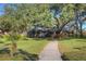 Well-maintained community building with lush landscaping and a charming walkway at 17917 Clear Lake Dr, Lutz, FL 33548
