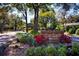 Entrance to Crystal Lakes Manors community, featuring lush landscaping and brick signage at 17917 Clear Lake Dr, Lutz, FL 33548