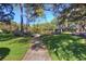 Community park featuring lush landscaping, walking path, and playground area at 17917 Clear Lake Dr, Lutz, FL 33548