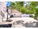Back exterior of house with basketball hoop and fenced yard on a sunny day at 17917 Clear Lake Dr, Lutz, FL 33548