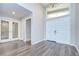 Bright foyer boasts hardwood floors, a chandelier, and decorative glass doors at 17917 Clear Lake Dr, Lutz, FL 33548