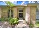 Charming front entry with brick pillars, arched windows, and mature landscaping at 17917 Clear Lake Dr, Lutz, FL 33548