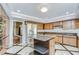 Bright kitchen features stainless appliances, granite countertops, wood cabinets, tile flooring, and a kitchen island at 17917 Clear Lake Dr, Lutz, FL 33548