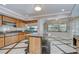 Bright kitchen features granite countertops, wood cabinets, tile flooring, and a kitchen island at 17917 Clear Lake Dr, Lutz, FL 33548