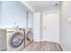 Laundry room with front-load washer and dryer, cabinets, and a door to the outside at 17917 Clear Lake Dr, Lutz, FL 33548
