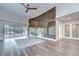 Expansive living room with hardwood floors, sliding glass doors to the pool, and mirrored wall at 17917 Clear Lake Dr, Lutz, FL 33548