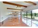 Spacious living room with wood flooring, exposed beams, fireplace and lake view at 17917 Clear Lake Dr, Lutz, FL 33548