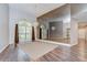 Formal dining room featuring hardwood floors, large windows, and mirrored wall at 17917 Clear Lake Dr, Lutz, FL 33548