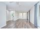 Spacious main bedroom with dark wood floors, a ceiling fan, bathroom access, closet space and patio doors at 17917 Clear Lake Dr, Lutz, FL 33548