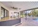 Outdoor kitchen with granite counters, a sink and faucet, as well as a view of the pool at 17917 Clear Lake Dr, Lutz, FL 33548