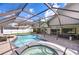 Large screened-in pool area with a hot tub, outdoor kitchen and lots of space at 17917 Clear Lake Dr, Lutz, FL 33548