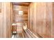 This is a beautiful home sauna with wood paneling, a heater, bucket and benches for comfort at 17917 Clear Lake Dr, Lutz, FL 33548